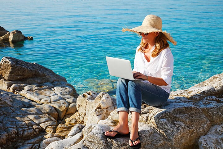 woman laptop beach